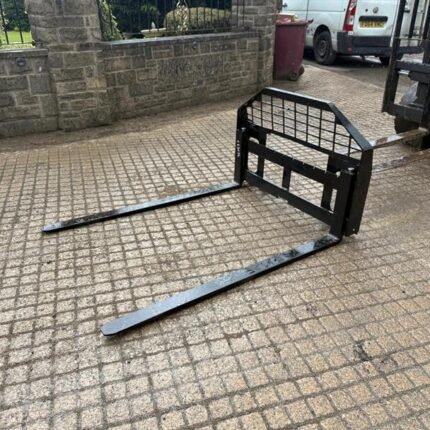 5ft steel pallet forks mounted on skidsteer frame